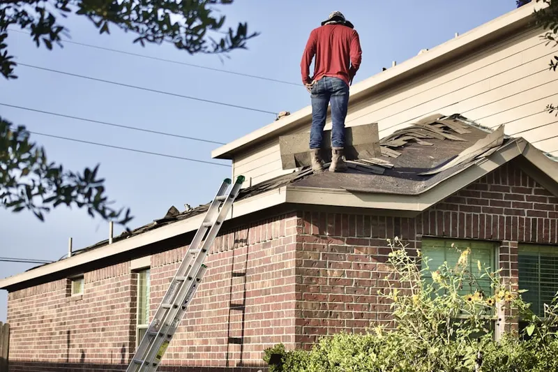 Professional roofer working on a residential roof in West Latonia